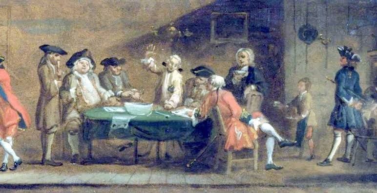 Men in eighteenth-century dress gathered around a table in a coffee house, one of them standing with a raised hand mid-argument, papers spread in front of them, a boy carrying a tray of coffee behind.